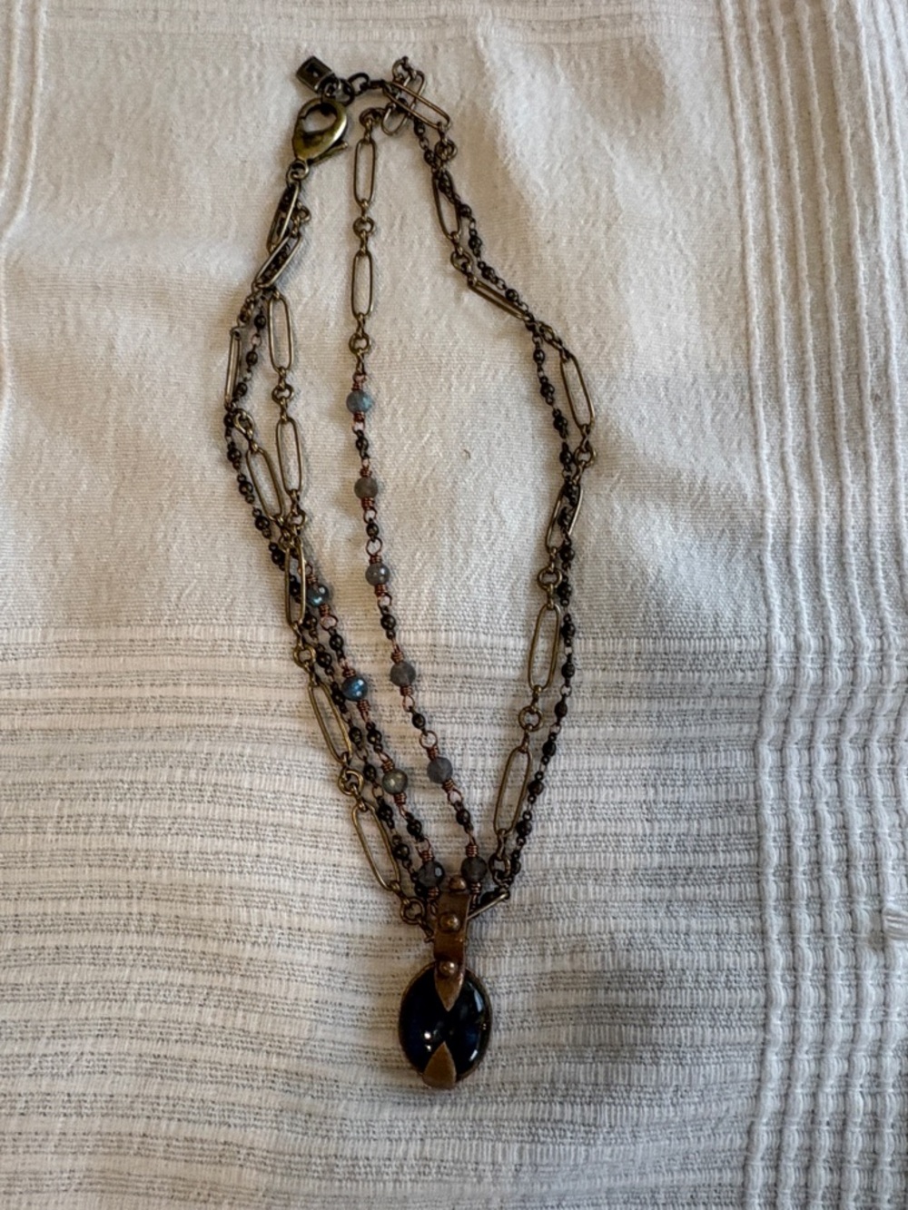 Layered Antique Brass Necklace with Blue Pendant and Beaded Accents